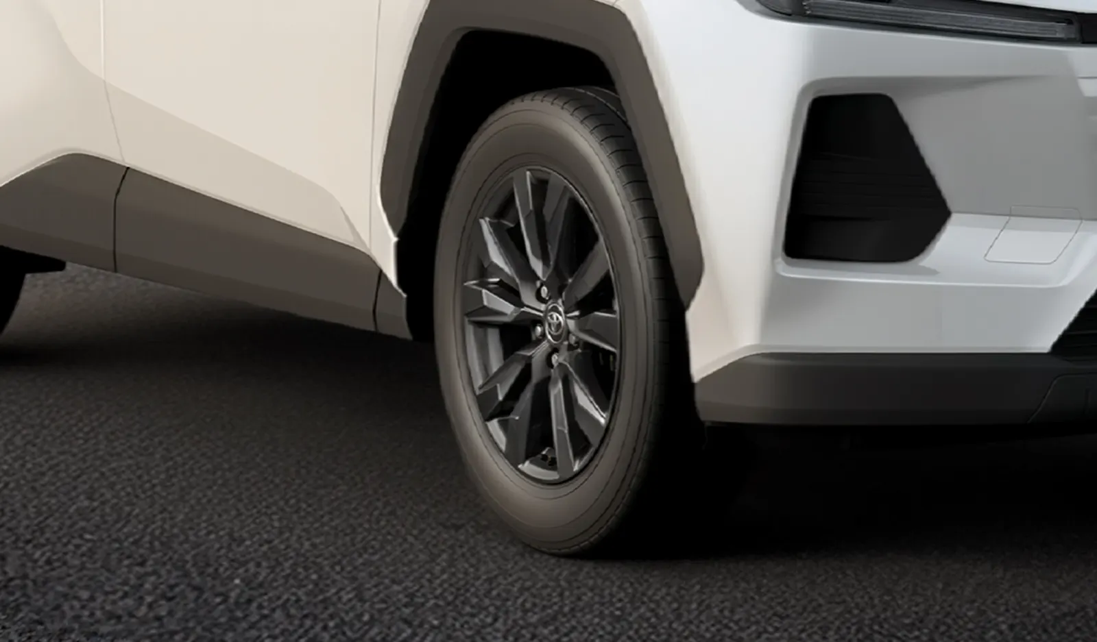 Rin de aleación oscuro y defensa delantera de la RAV4 2026 blanca